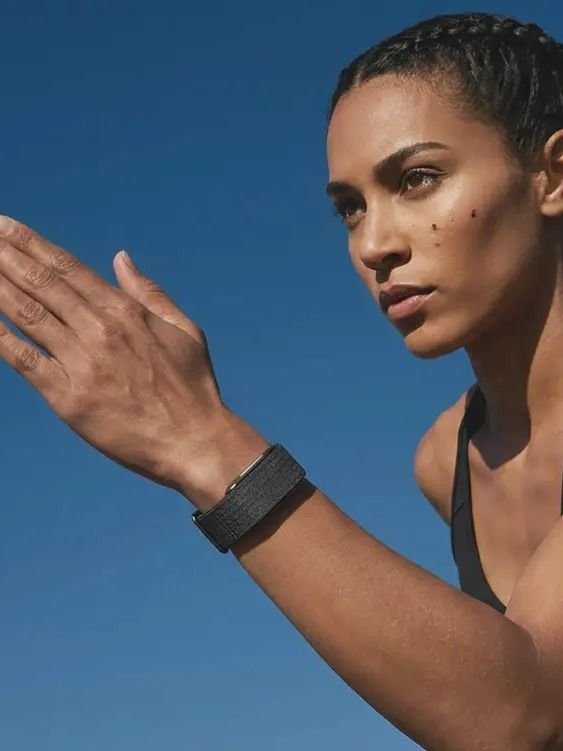 Athletic woman outdoors wearing the Hume Band, building metabolic momentum